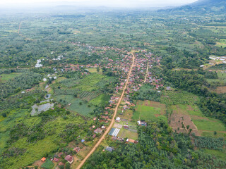Rural Village Aerial: A breathtaking aerial view of a charming rural village nestled amidst rolling...