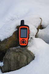 Close-up, of a Satellite Communicator with GPS Navigation outside outside in the snow