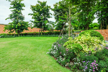 Multi-colored flower bed in the park,cute colorful in backyard,Lots of beautiful summer flowers,Lush bright flowering in the garden,Multicolor blooming,Outdoor summer gardening,space for text.