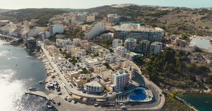 Aerial view of Bugibba on the island of Malta. Urban landscape of the streets of the city of architecture in the touristic city of the Mediterranean. High quality 4k footage