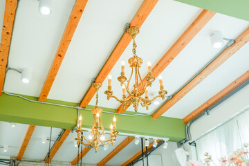 Luxury old lamp hanging at restaurant,chandelier lamp with crystal sparkle golden light furniture decorated in elegant hotel for gala dinner,copy space.