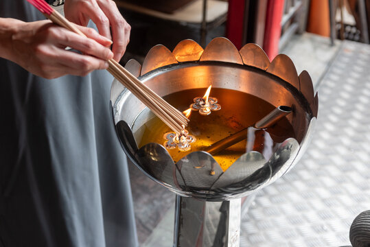 Man Who Lights Incense Sticks At The Hindu Temple In Singapore - Powered by Adobe