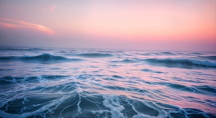 Obraz premium A picturesque sunset with clear blue sky and colorful horizon reflected on the calm ocean landscape . Bright shades of orange and pink create a tranquil atmosphere. For projects about nature, 