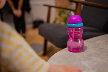 Small toddler pink safety water bottle with inbuilt straw for safe drinking and toddler hand...