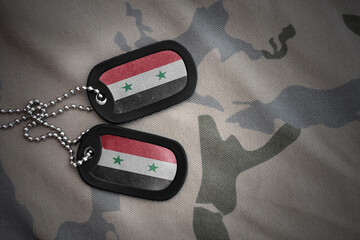 army blank, dog tag with national flag of syria on the khaki texture background. military concept.