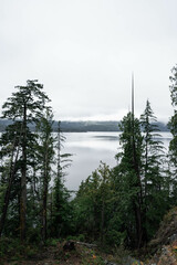 Moody lake on Vancouver Island, Canada, with mountains in the background on a cloudy november day