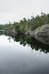 Moody lake on Vancouver Island, Canada, with mountains in the background on a cloudy november day