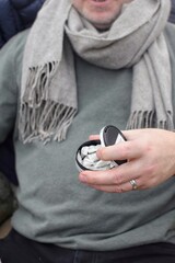 An adult man opens a box of nicotine snus 