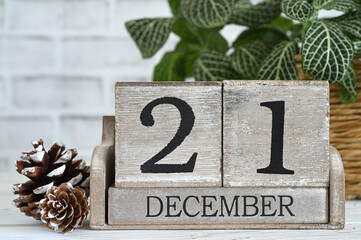 First Day of Winter aka Winter Equinox or solstice - December 21 on a wooden block calendar sitting...