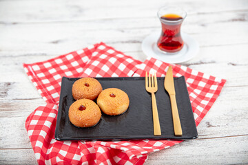 Sekerpare dessert. Ramadan dessert. Sekerpare dessert with syrup and Turkish tea on a serving plate.