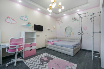 Cozy children's room in pastel colors. Bright furniture, beautiful decor. Children's sports .complex.