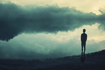 Fototapeta premium Silhouette person, calm water, misty sky, serene scene.