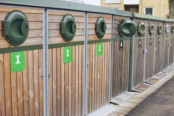 A row of wooden boxes for separate waste collection.