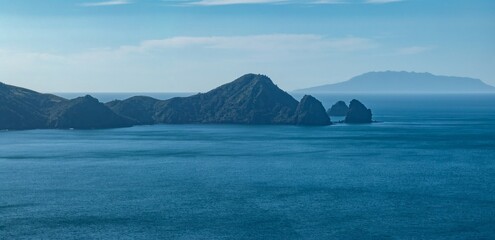 Tranquil ocean scene with distant islands. Calm waters meet the horizon. Coastal landscape. , PORT...