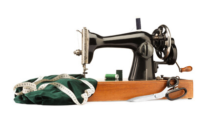 Sewing machine with green fabric, measuring tape, scissors and spools of threads isolated on white