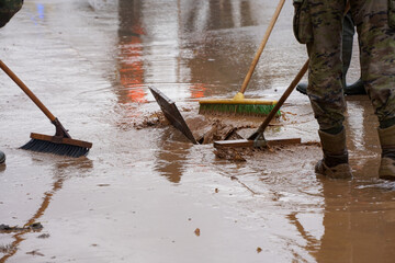 Cleaning the streets with water and brushes, soldiers and firefighters, all united, clean the...