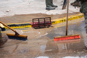 Cleaning the streets with water and brushes, soldiers and firefighters, all united, clean the...