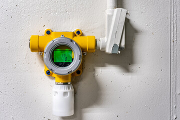 Yellow wall mounted industrial carbon monoxide gas monitoring detector, device in an industrial...