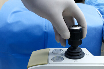  LASIK Machine Bed Joystick Operated with Gloved Hand © Mohammed