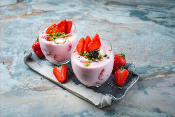 cream cheese dessert with mascarpone cream, vanilla curd with fresh strawberries and green...