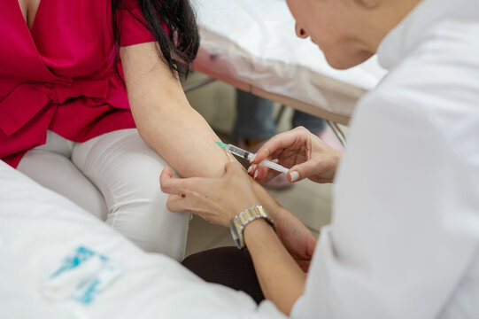 two cosmetology students are learning from each other to do botox injections. Introduction of the syringe. Cosmetology