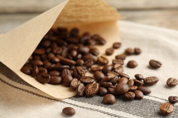 Paper filter and coffee beans on cloth, closeup