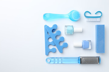 Set of pedicure tools on light background, flat lay. Space for text