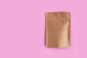 Kraft brown paper empty bags isolated mock up on light pink background. Eco friendly pack with zipper, roasted specialty coffee beans, tea, snack, alternative sample trendy concept. top view, flat lay