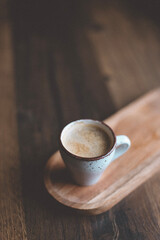 hot cup of coffee on wooden plate, flatlay, cozy autumn or winter holiday