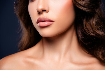 Fototapeta premium Glamorous young woman with flawless skin against a dark grey background exuding elegance and beauty