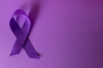 Purple background with International Cancer Day symbol .Copy space