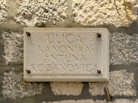 Korcula, Croatia - June 30, 2024: Kanonika Antuna Rozanovica alley name sing on old stone wall