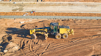 Grader leveling ground on a building site