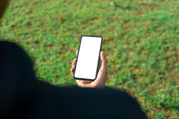 Mockup image of a man using smartphone with blank white screen at outdoor