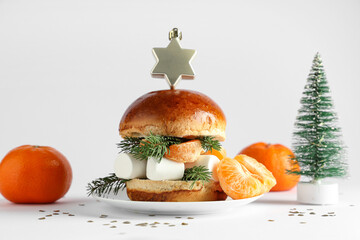 Tasty burger with tangerines and marshmallows on light background