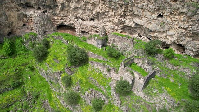 Orbital aerial shot of remains of Horomayri monastery on a spring day. Odzun village, Armenia.