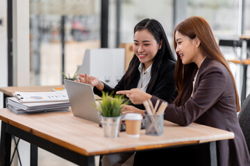 Business financing accounting banking concept. Two asian Business doing finances and calculate on...