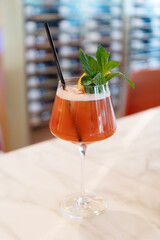 Cocktail drink. Aperitif in the bar. Summer refreshing cocktail. Drinking alcohol beverage. Glass of cocktail aperitif beverage. Summer drink. Cocktail in bar. Lemonade drink in glass