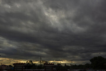 Dramatic sky with dark clouds at sunset. Nature background.