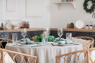 Beautiful Christmas table setting in interior of kitchen