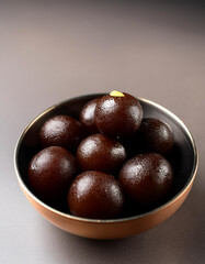 Obraz premium Kala Jamun or Black Gulab Jamun is a delicious and juicy sweet snack