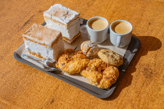 Sitting in a bakery outside eating almond sweats and drinking coffee in tejeda, spain. with Roque Bentayga in the background, Gran Canaria, Canary Islands, Spain near the Roque Nublo in the Mountains.