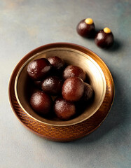 Obraz premium Kala Jamun or Black Gulab Jamun is a delicious and juicy sweet snack