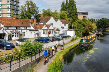 Cyclist riding on the towpath alongside the Grand Union Canal at Uxbridge, London, England