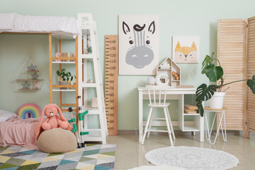 Interior of children's room with bunk bed, toys and table