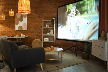 Interior of dark living room with projector screen, sofa and glowing lamps at night