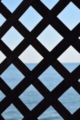 silhouette rectangular  wooden  lattice background  with blue sea and sky.perfect scale of lattice