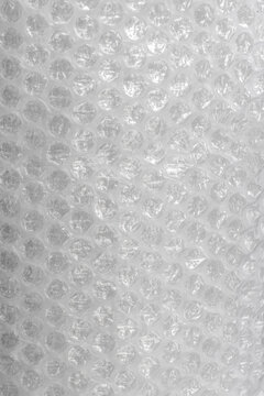 Close up view of bubble wrap, a common packing material. The image showcases the distinctive pattern of air-filled bubbles, which are designed to protect delicate items during shipping