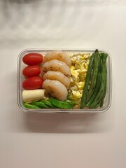 A traditional Korean dosirak, beautifully arranged with rice, assorted banchan, and savory proteins. Balanced and visually inviting, it’s a portable meal packed with vibrant flavors.
