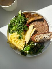 A delightful brunch spread featuring a mix of savory and sweet dishes, including fresh pastries, eggs, seasonal fruits, and a hot beverage. A perfect mid-morning indulgence.
